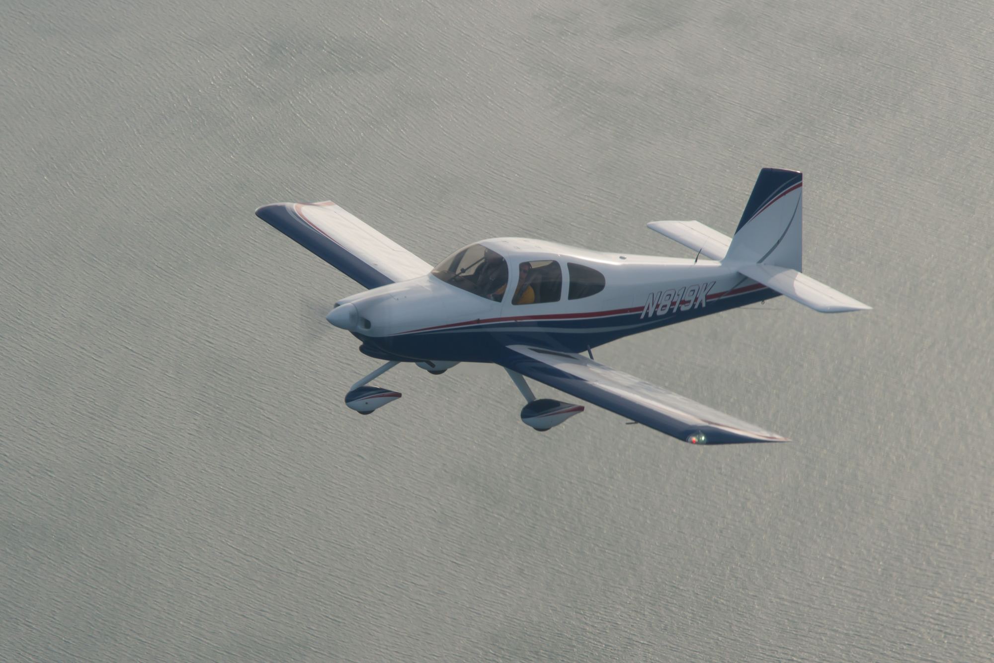 N819K in flight over the water